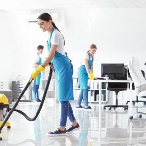 Three maids are cleaning the office space.