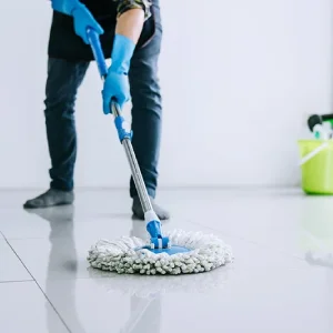 A maid is mopping the floor.