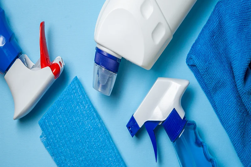 Three spray bottles filled with a cleaning solution.