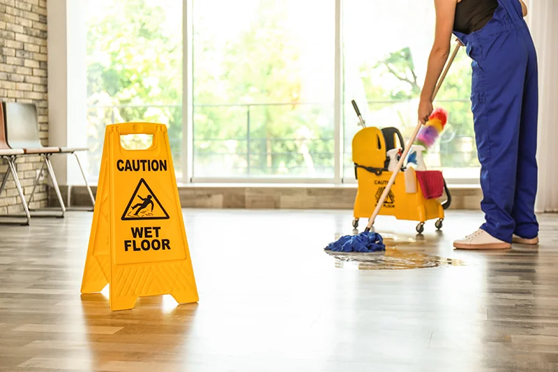 A maid is mopping the floor.