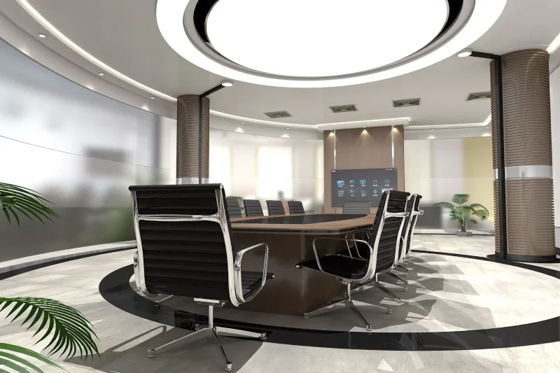A spacious, modern office, with a massive conference table and chairs.